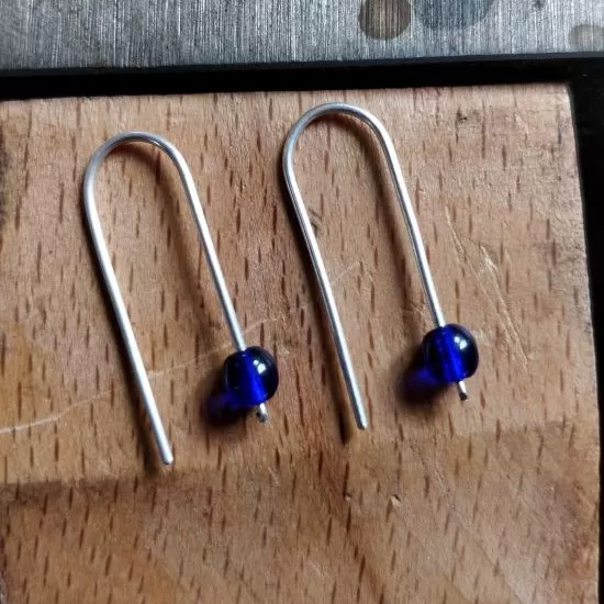Sterling silver beaded earrings. Available in mid blue, black and red.