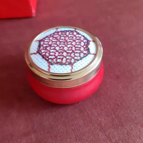 Small coloured ceramic pillbox with embroidered lid
