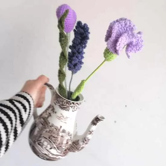 Crochet flowers in an coffee pot. 