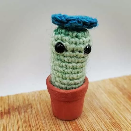 Tiny crochet cactus in a 1-2cm terracotta pot.