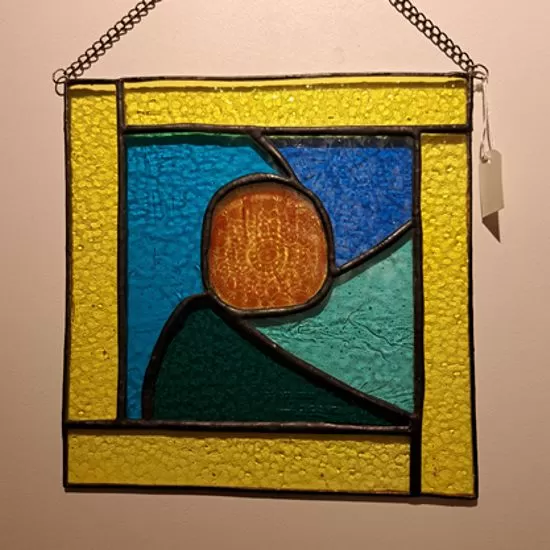 Orange in yellow frame stained glass panel
